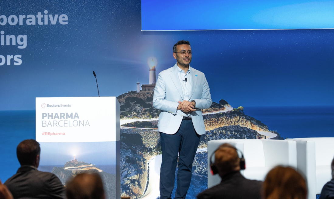 A speaker addressing the audience from the main stage at a Reuters Events conference
